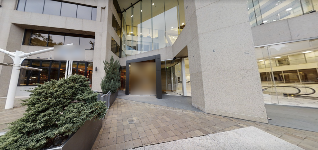 Glass entrance and paved walkway outside a downtown Washington, DC restaurant before the as-built survey