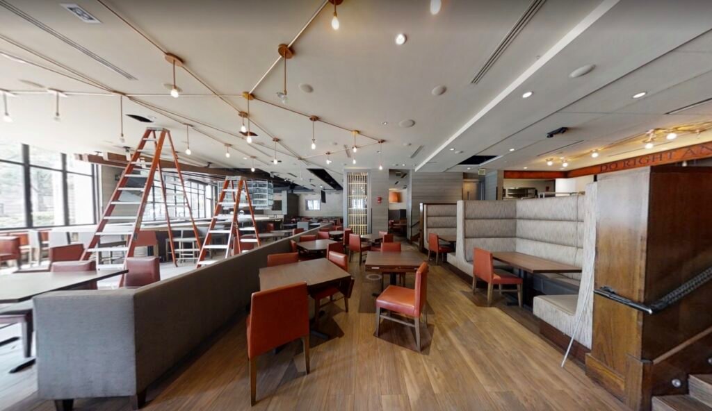 Matterport 3D tour of a Washington, DC restaurant dining area with booth seating, tables, and exposed pendant lighting